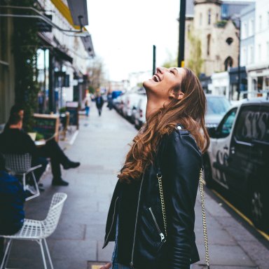 Woman laughing on street