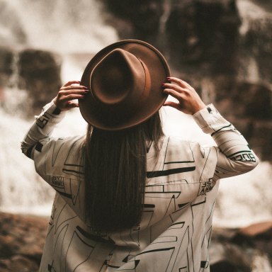 girl with a hat and a waterfall