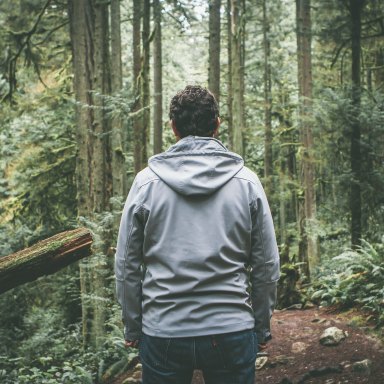 man back turned in the woods