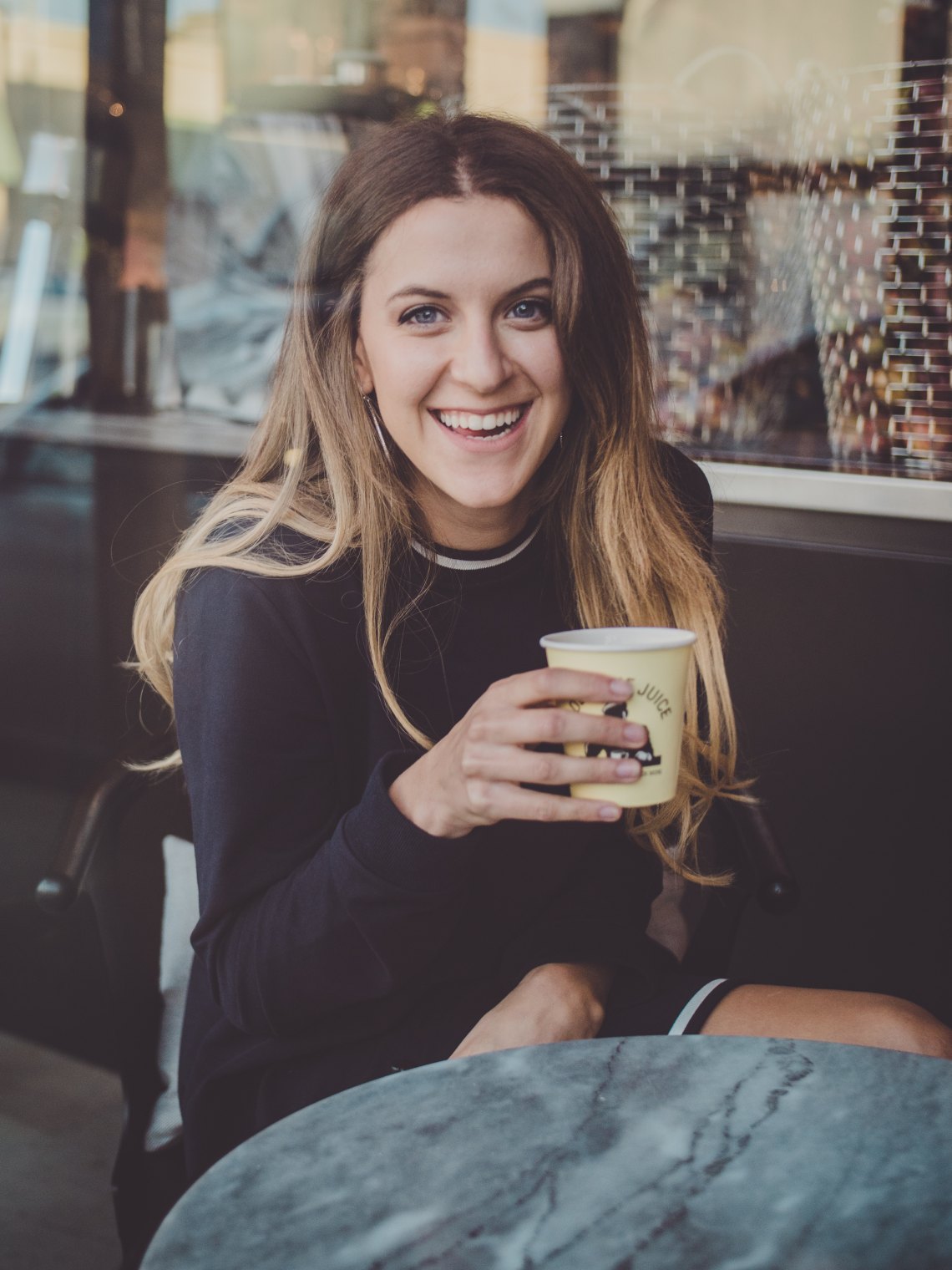 girl drinking coffee and laughing