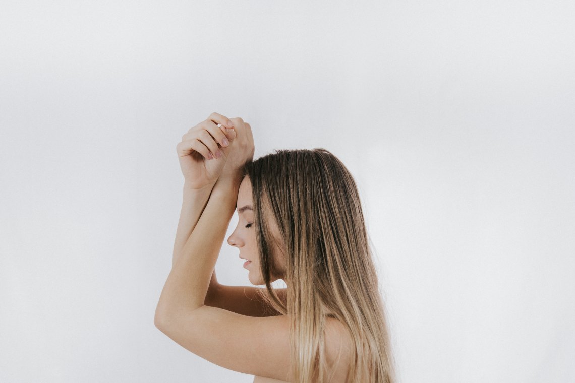 woman standing holding hands up