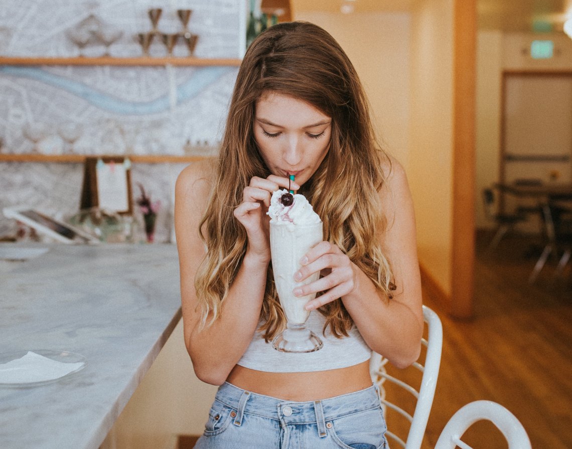 girl sipping a milkshake