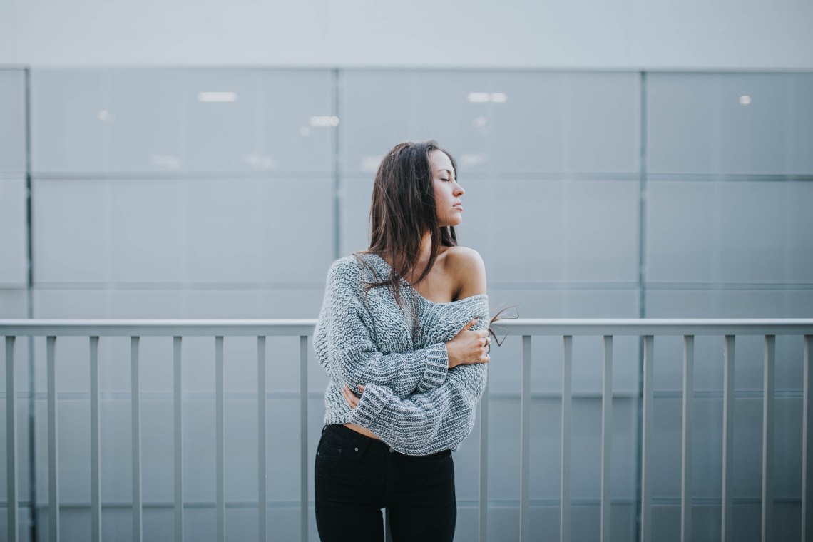 girl in a grey sweater eyes closed