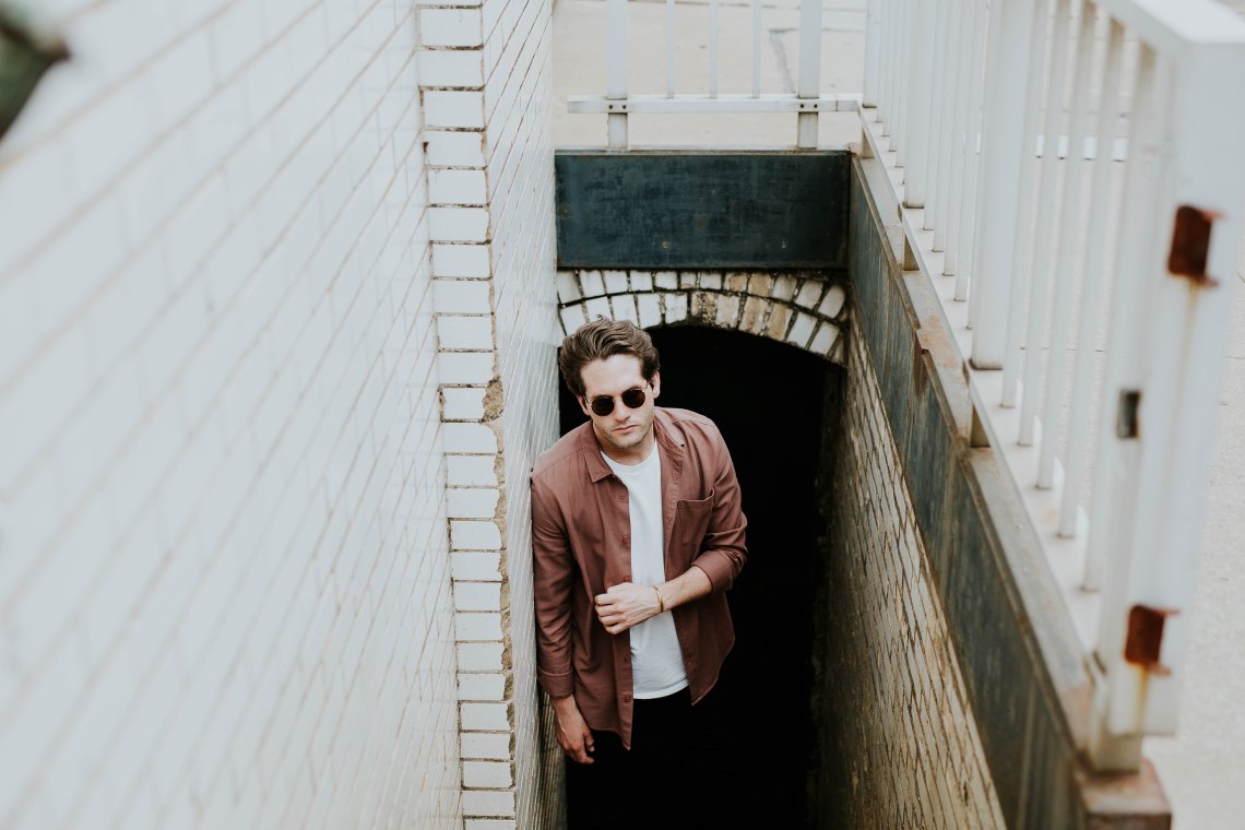 man next to white bricks