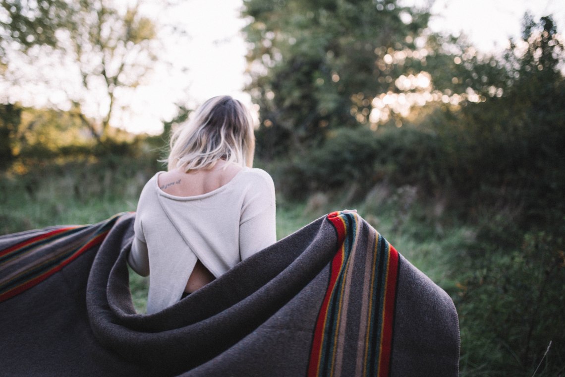 woman walking with a blanket