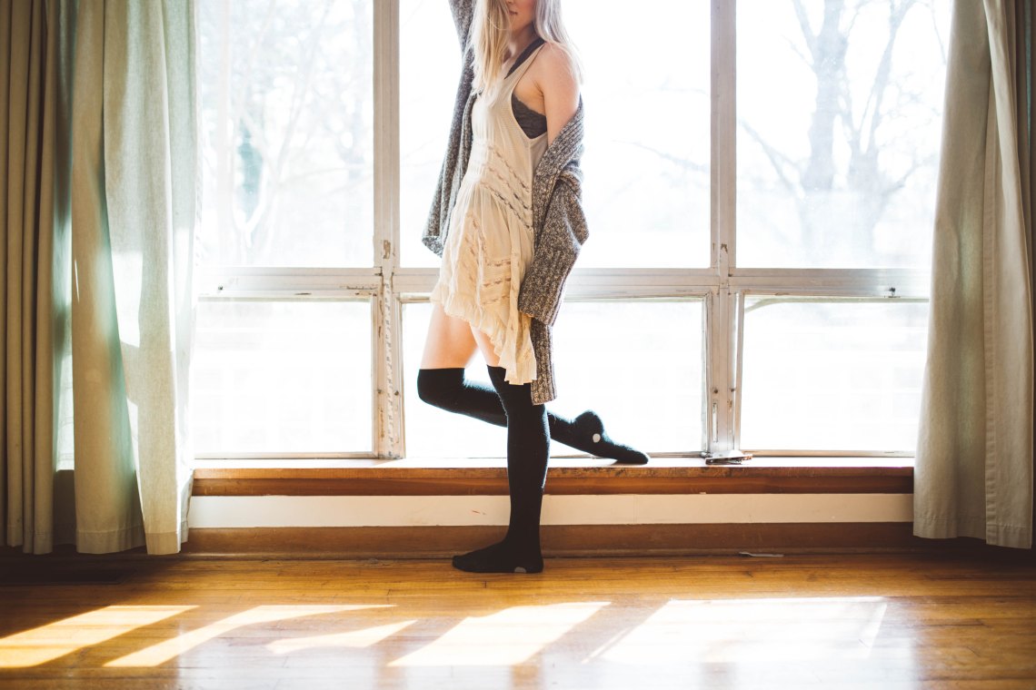 girl leaning by a window
