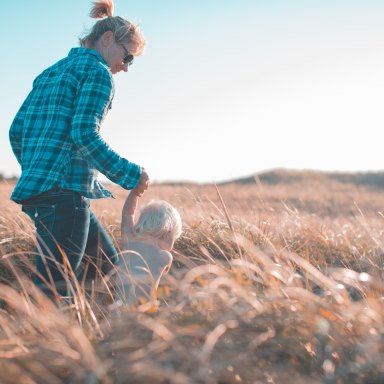Mom and kiddo running through a wheat field