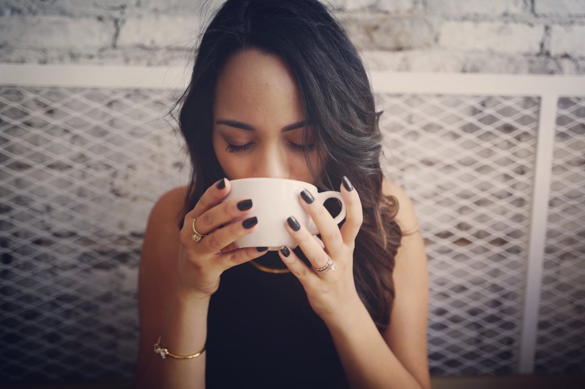 girl drinking coffee black nails