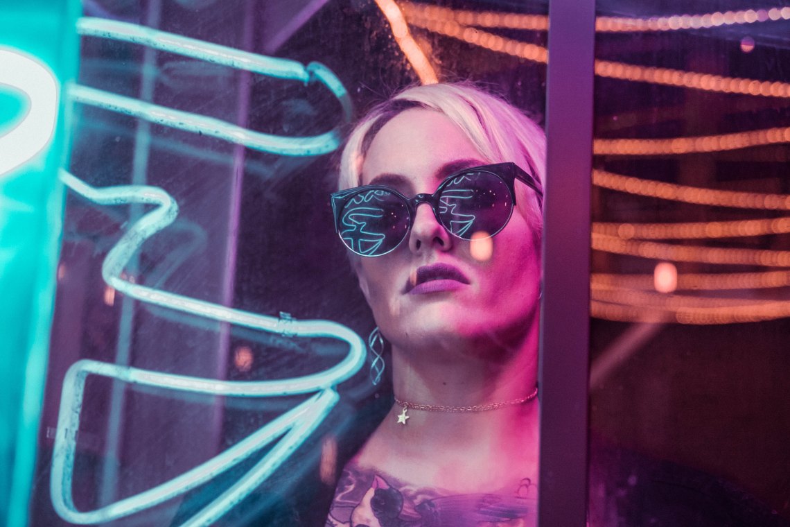Woman staring in neon lights