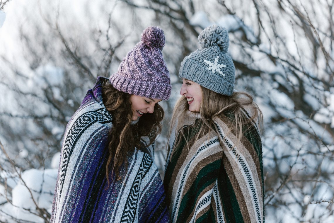 sisters laughing in blankets