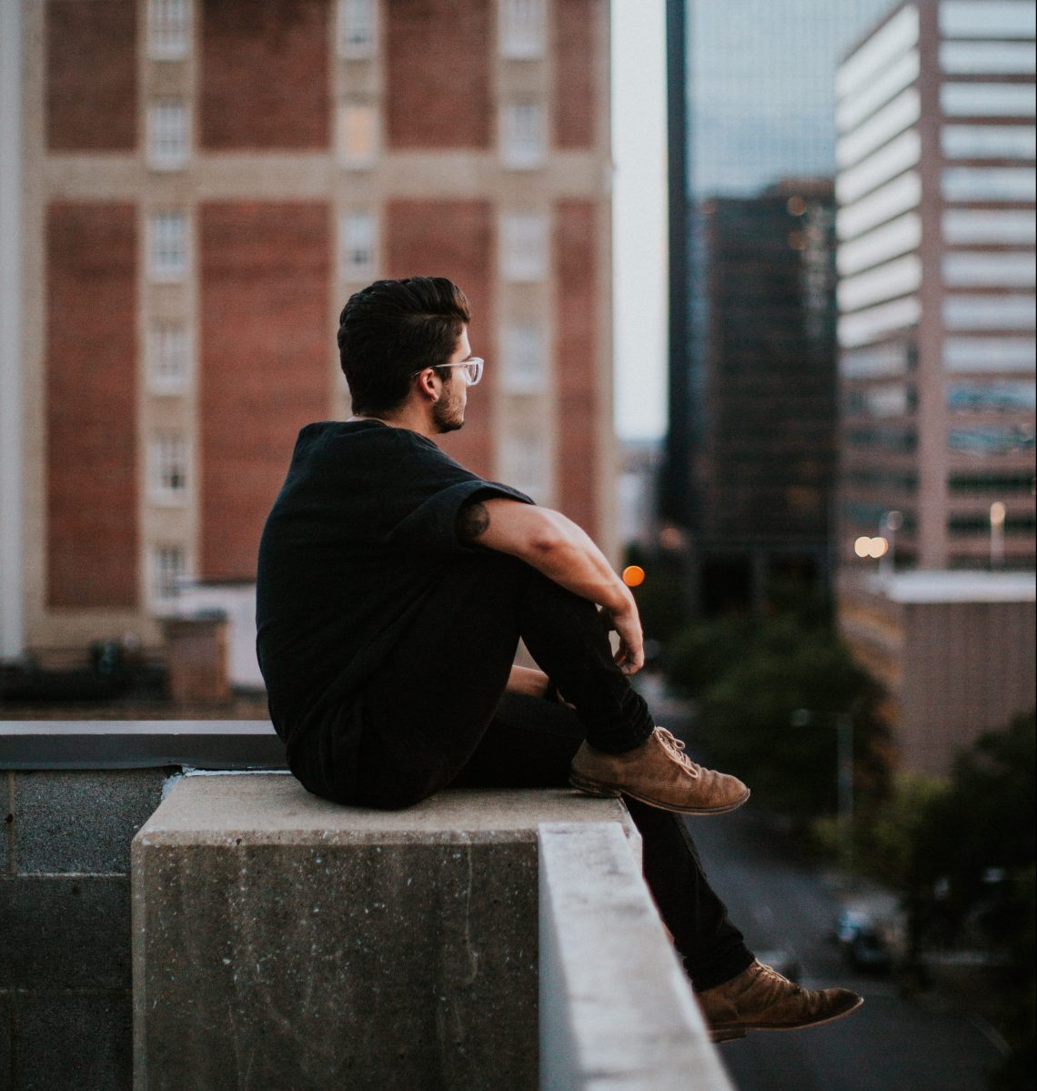 man sitting on ledge