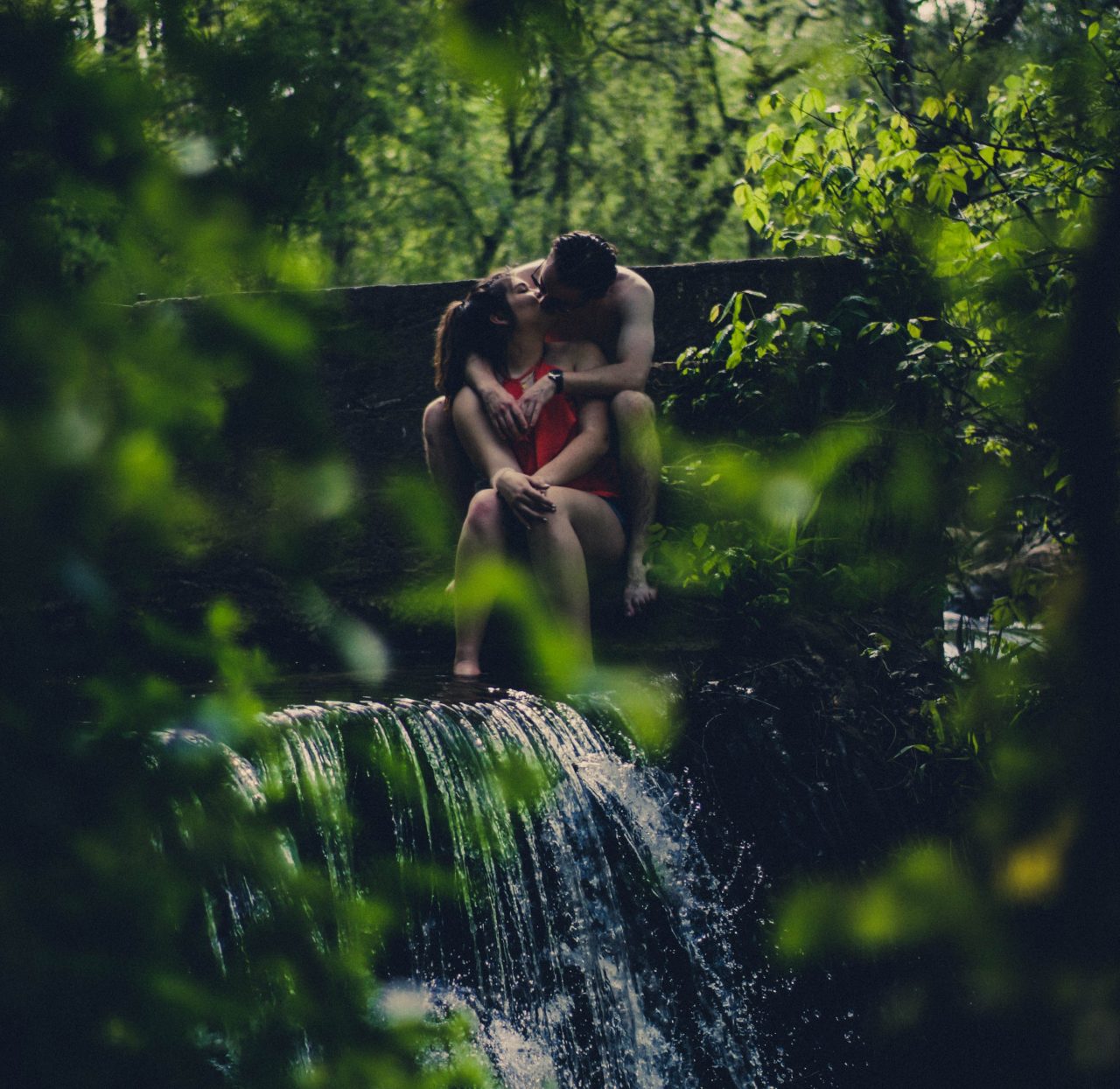 couple kisses in woods