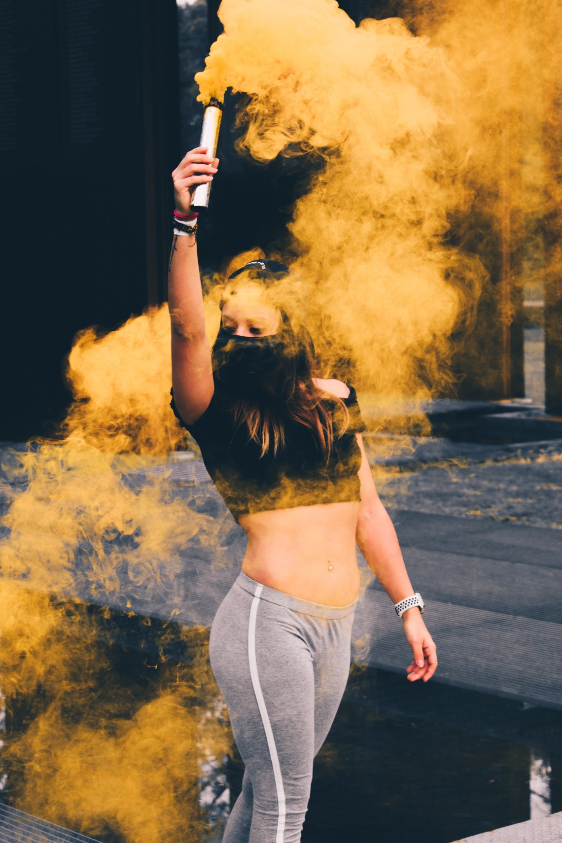 girl wandering around with yellow smoke