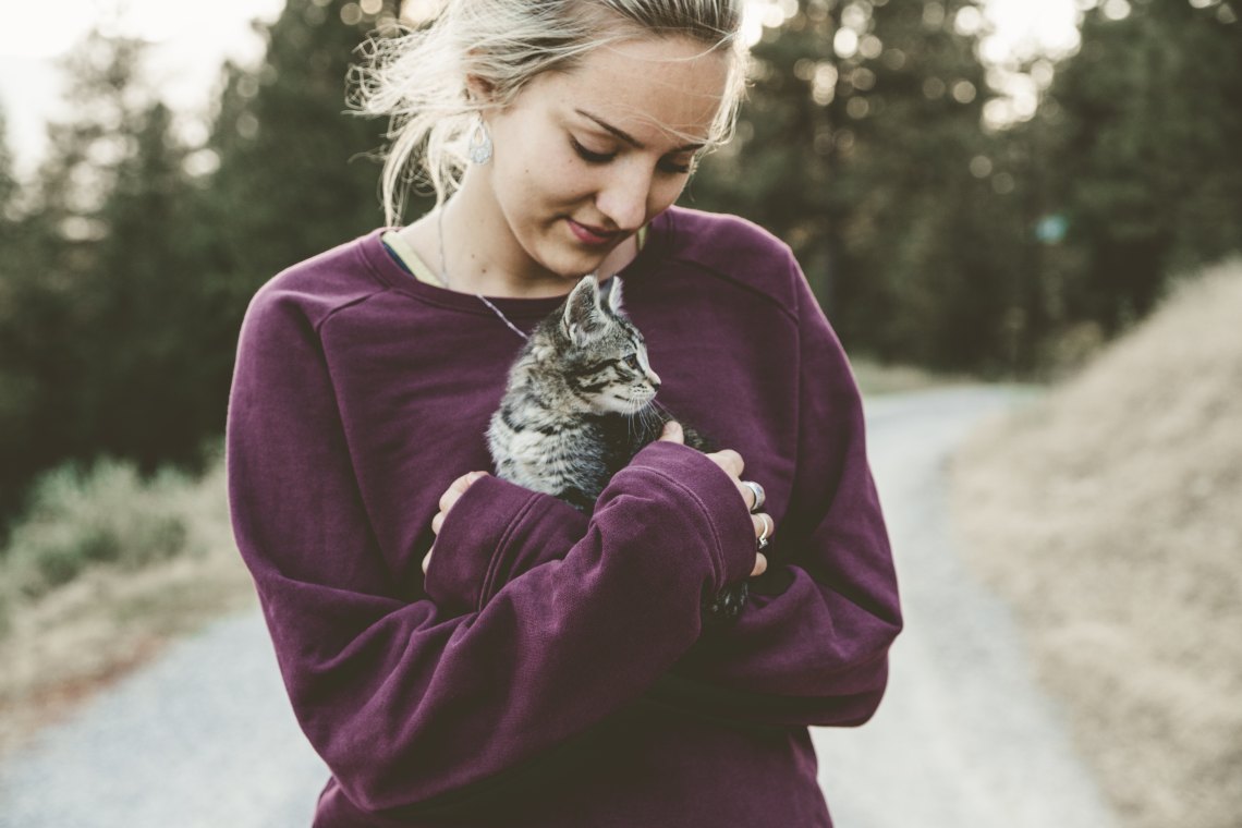 girl hugging her cat