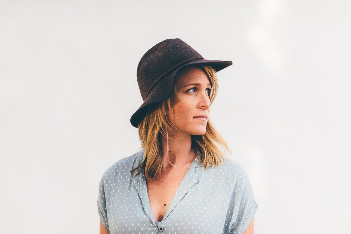 woman in hat looking to side