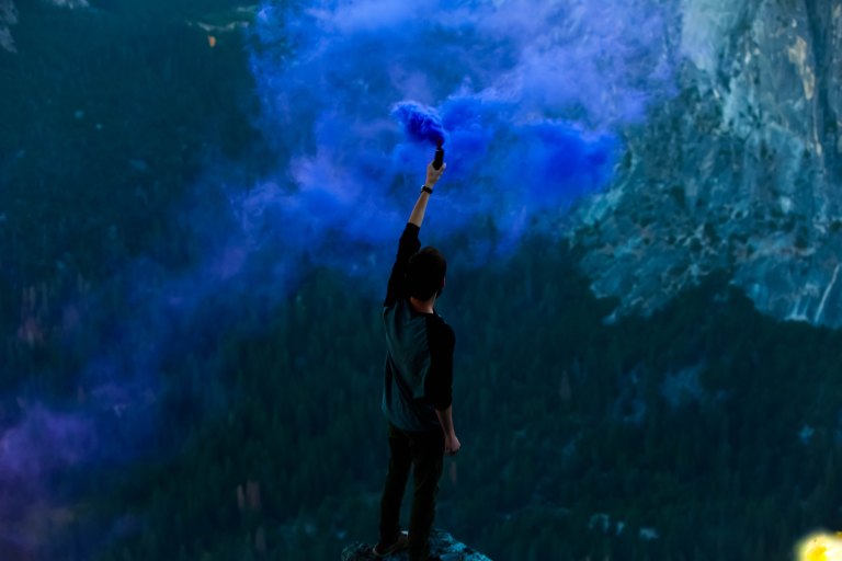 person with a bunch of blue smoke