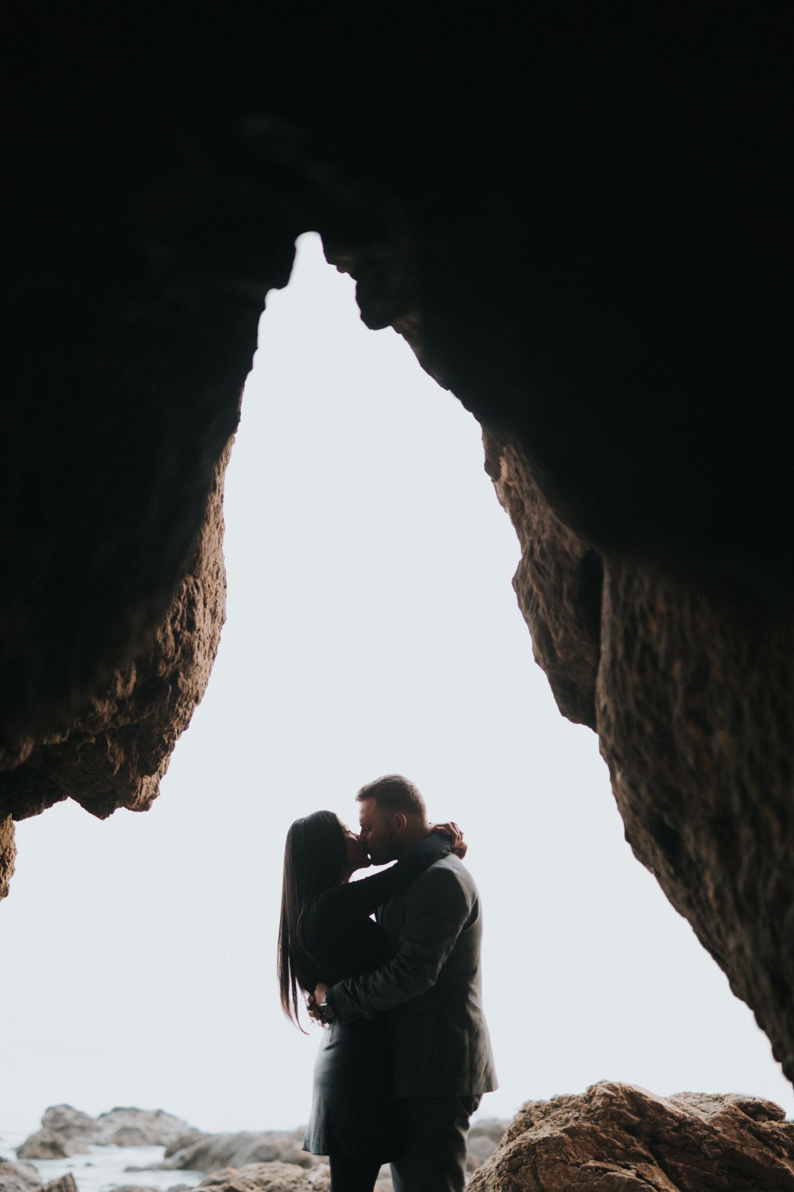 couple kissing in a very cool cave
