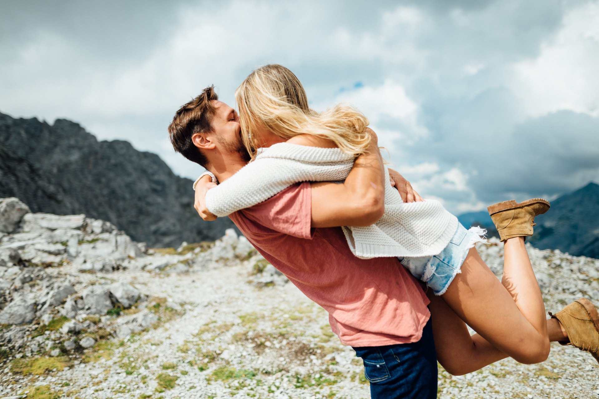 Guy and girl hugging on mountaintop