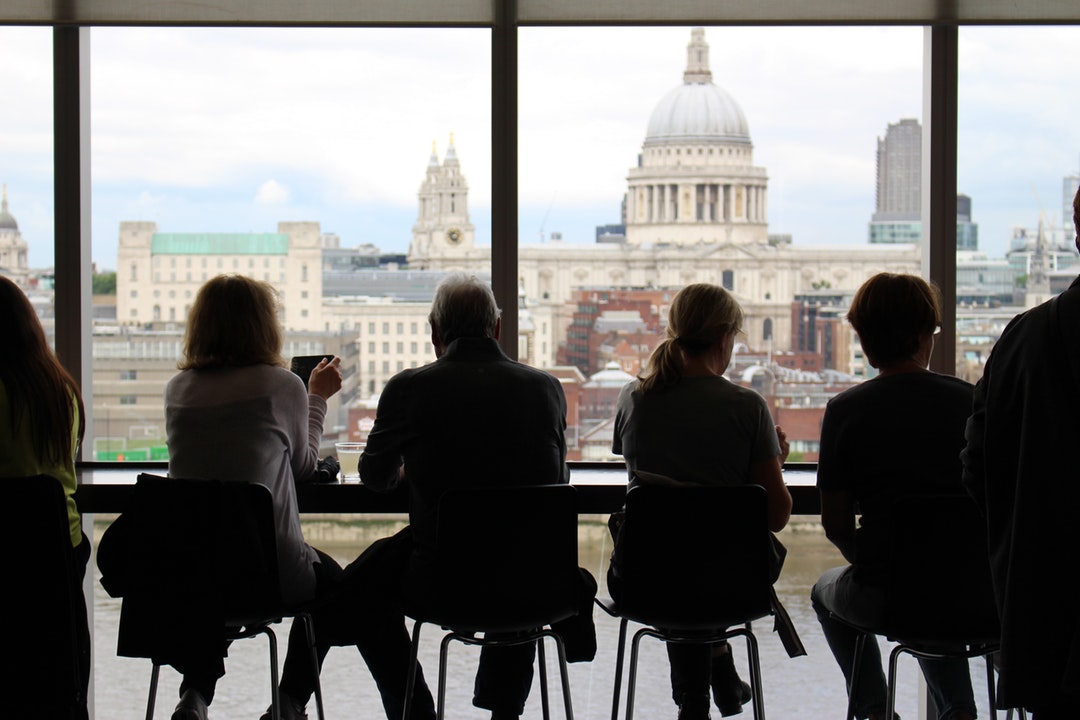People sitting at a table at a café with a view on St. Paul's Cathedral in London
