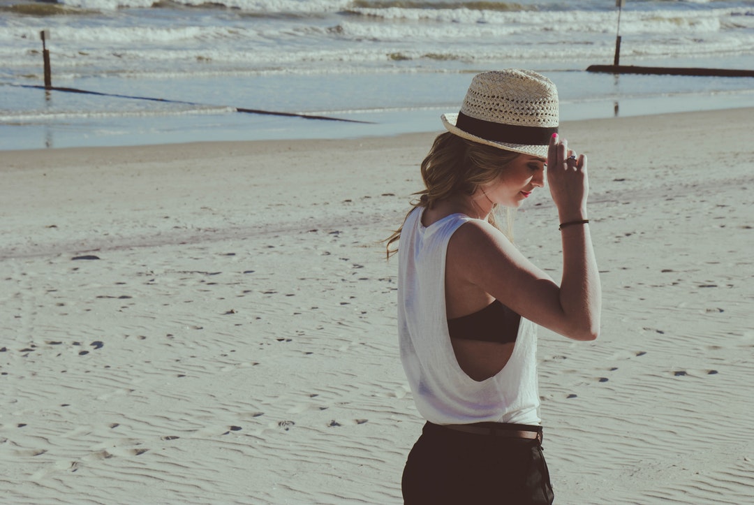 Woman with a hat on the Myrtle Beach sand coastline