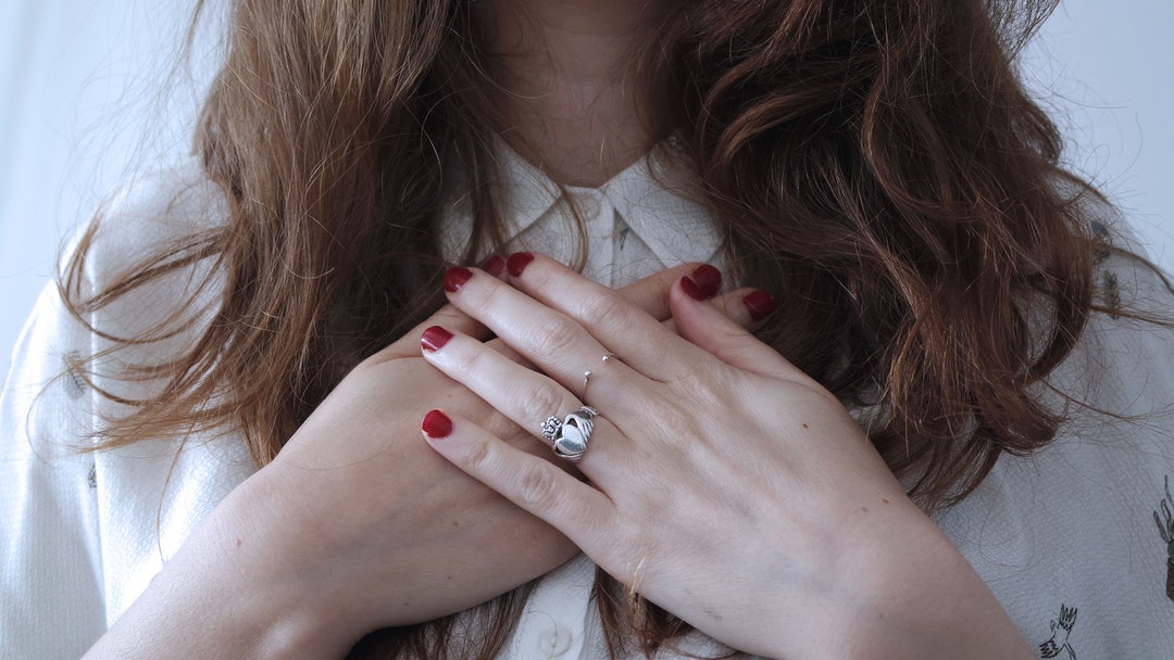 A woman with her hands crossed on her chest