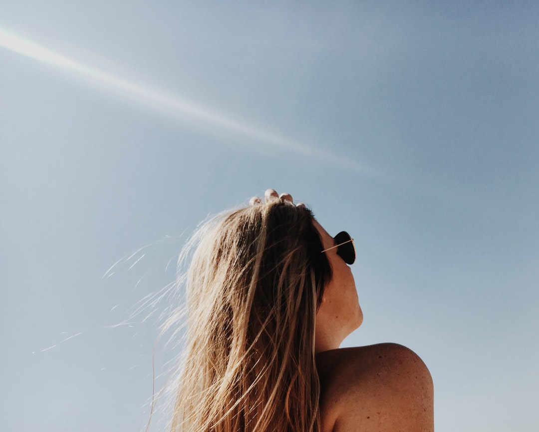 woman wearing gold framed Aviator sunglasses