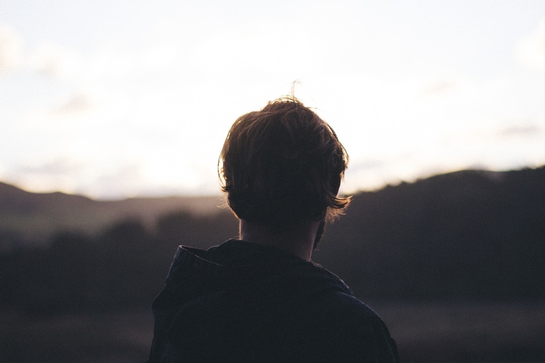 Portrait of a man from behind at Bethells Beach