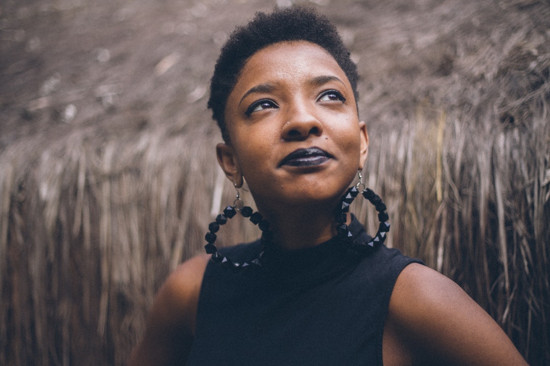 Confident chic woman looks up proudly