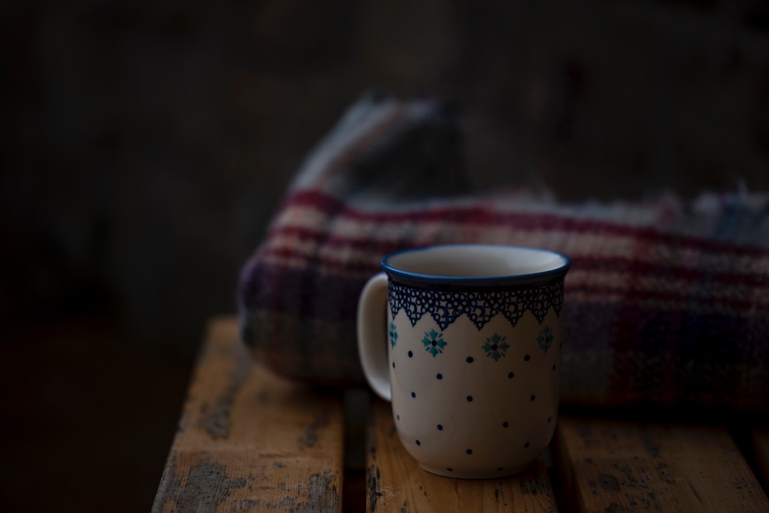 white and blue coffee mug