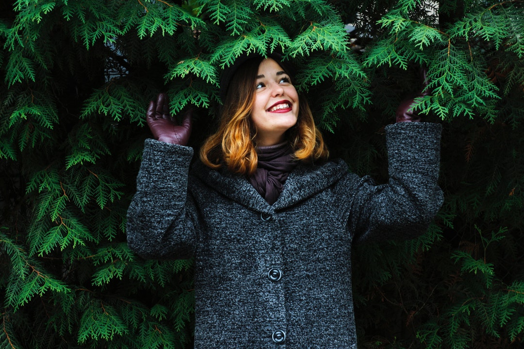 woman standing beside tree