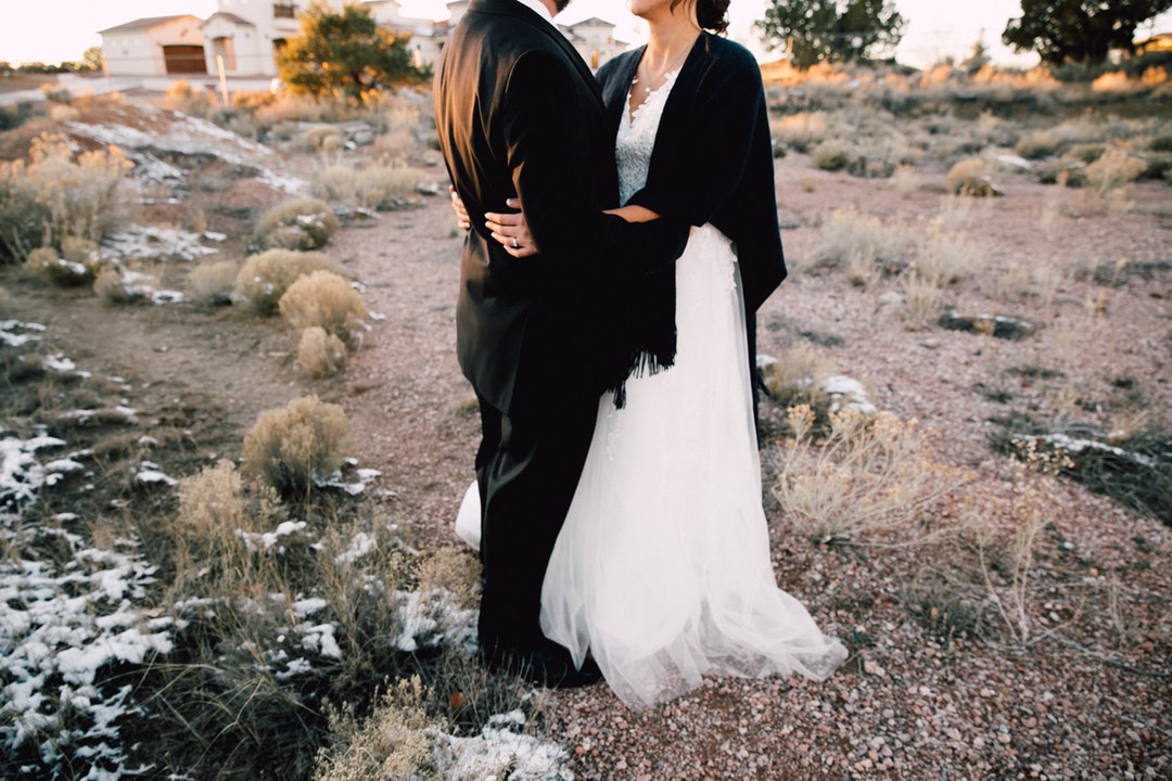 Bride and groom hold each other in Gallup at sunset