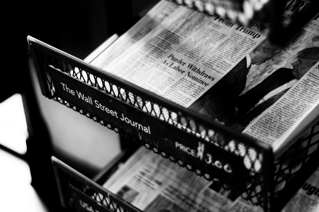 A black-and-white shot of newspapers in a store