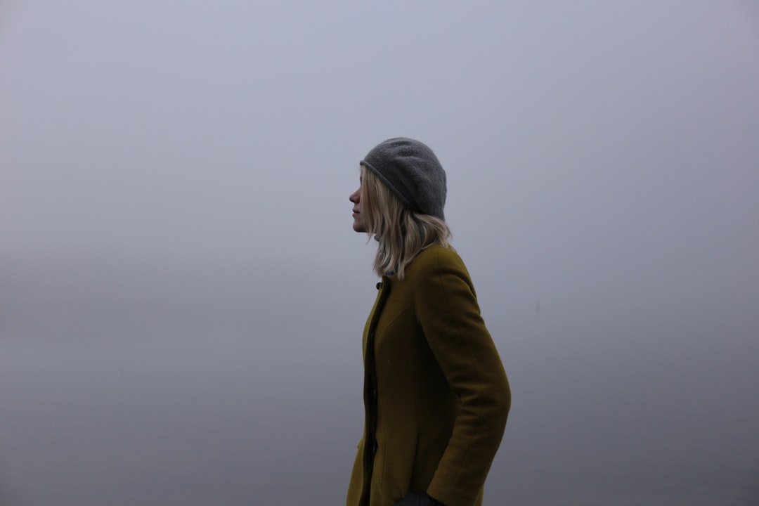Profile of fashionable woman outside in the fog