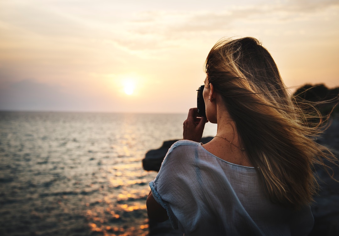 woman talking photo of body of water