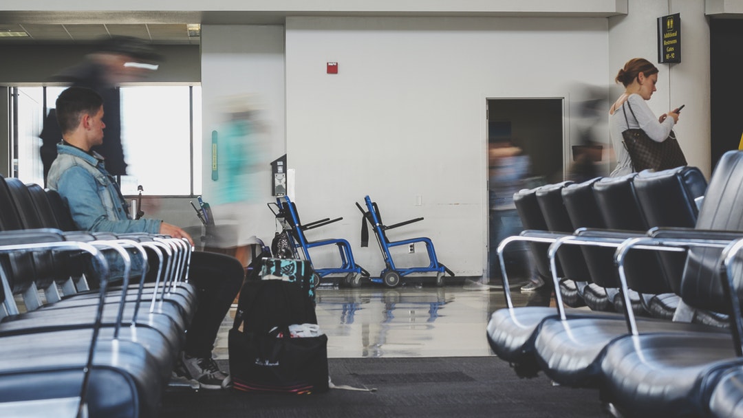 A man waiting at an airport lounge
