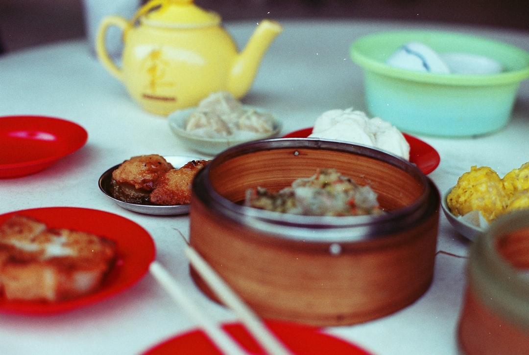 Chinese dim sum with dumplings and tea at a kitchen table