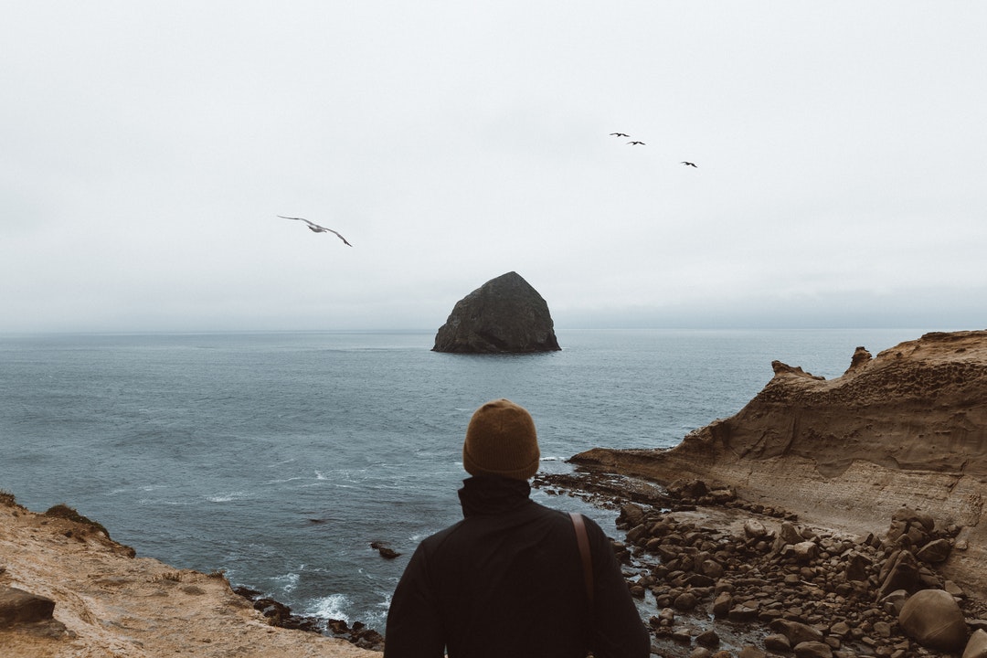 person wearing black jacket facing islet