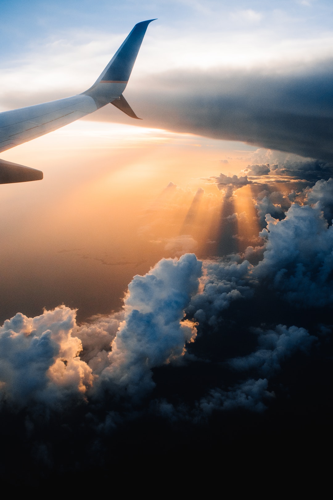 View from an airplane on fluffy clouds below