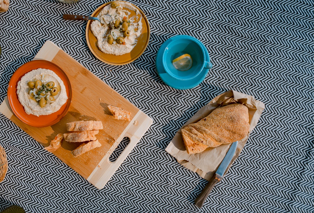 Colorful dishes, hummus, and bread at snack time in Cluj-Napoca