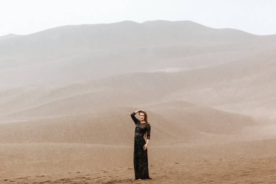woman standing on brown sands