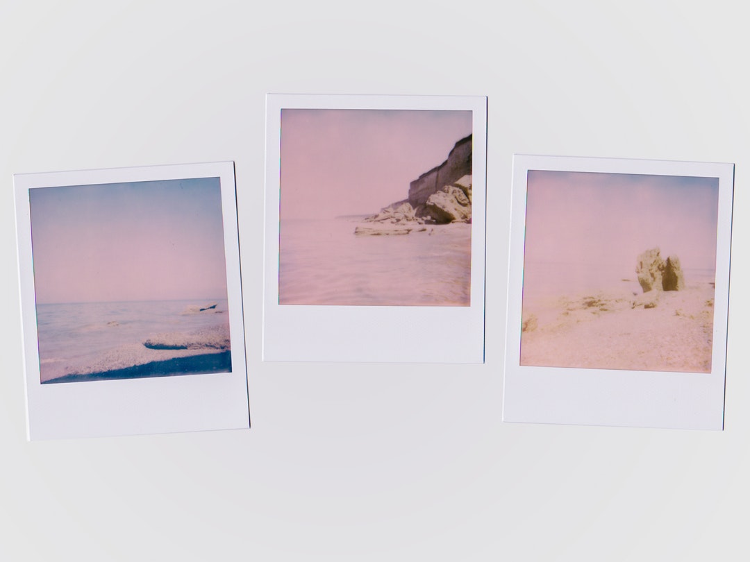 Three photographs of the ocean on a wall