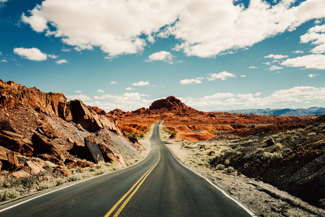 Open road in red rocky desert terrain of Valley of Fire State Park