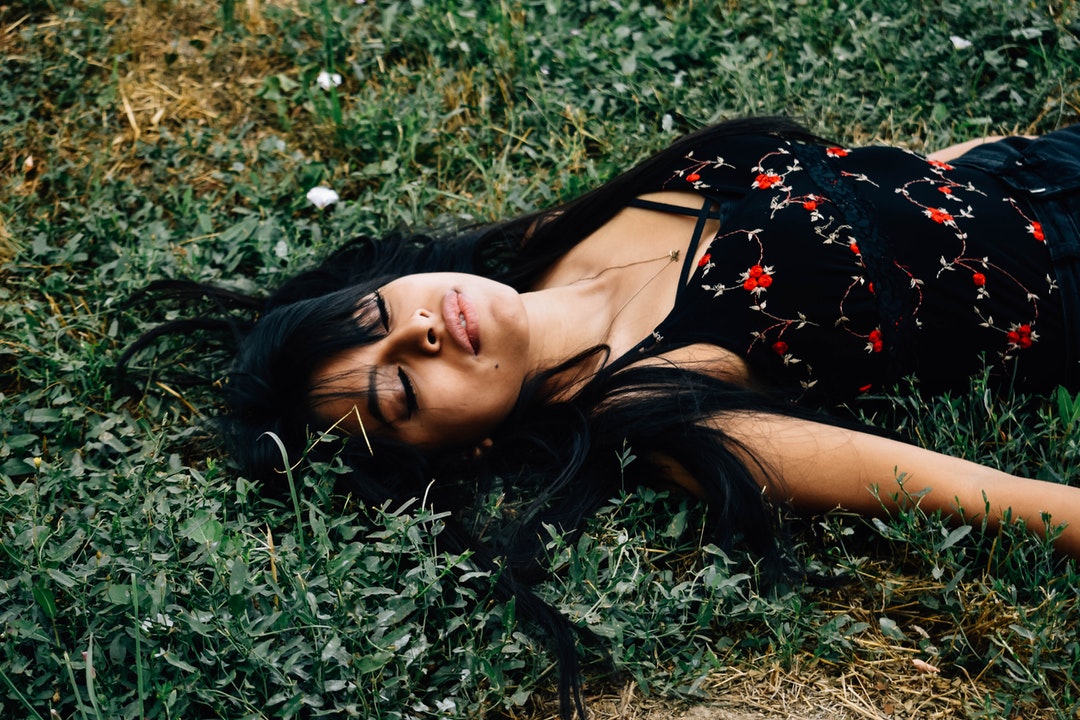 woman lying on ground at daytime