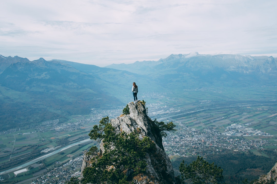 person standing on top of mountain