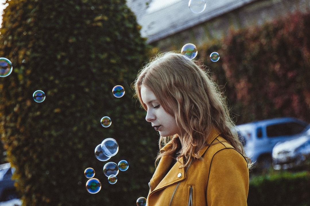 selective focus photography of woman with bubbles