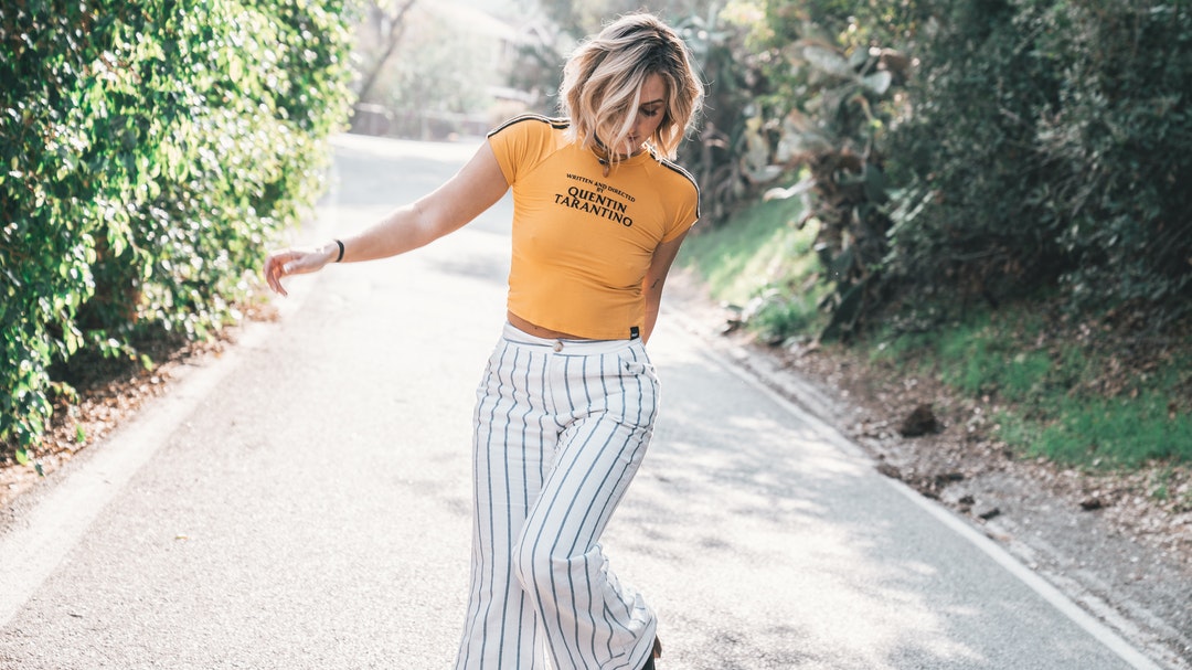 woman standing on gray road
