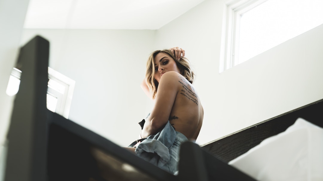 topless woman sitting inside room