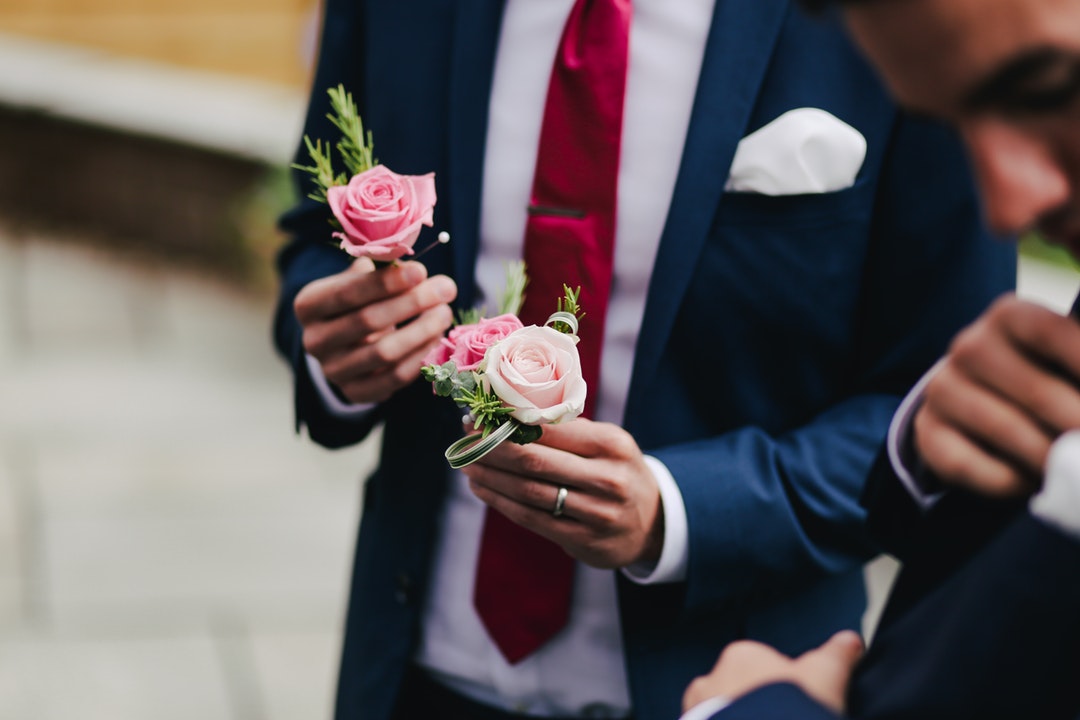 man holding pink roses