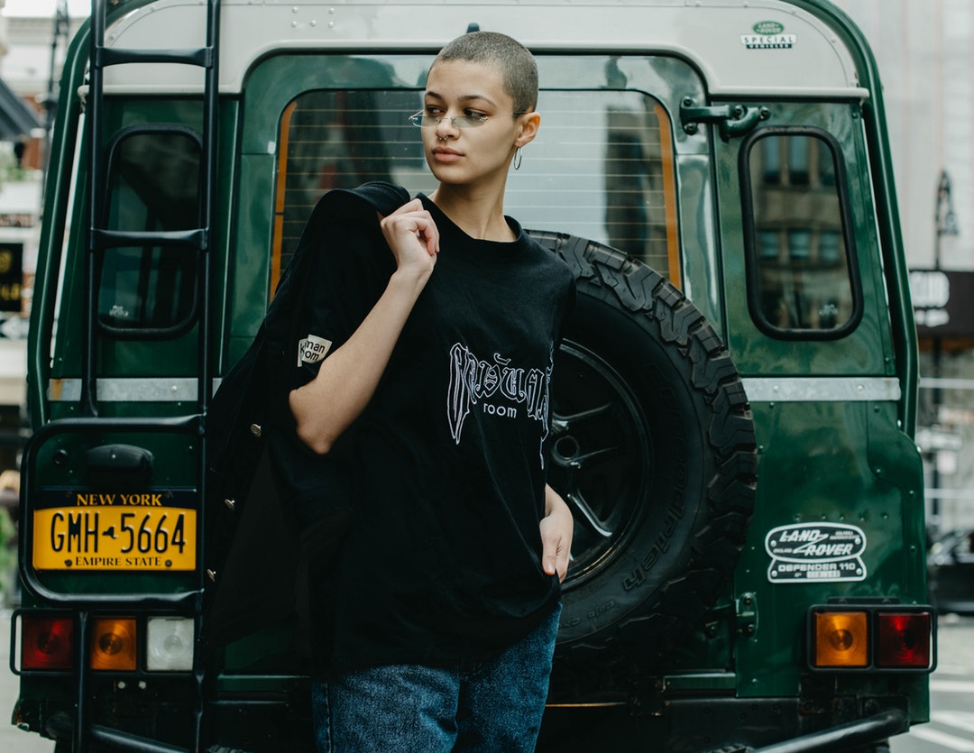 woman standing neat black vehicle