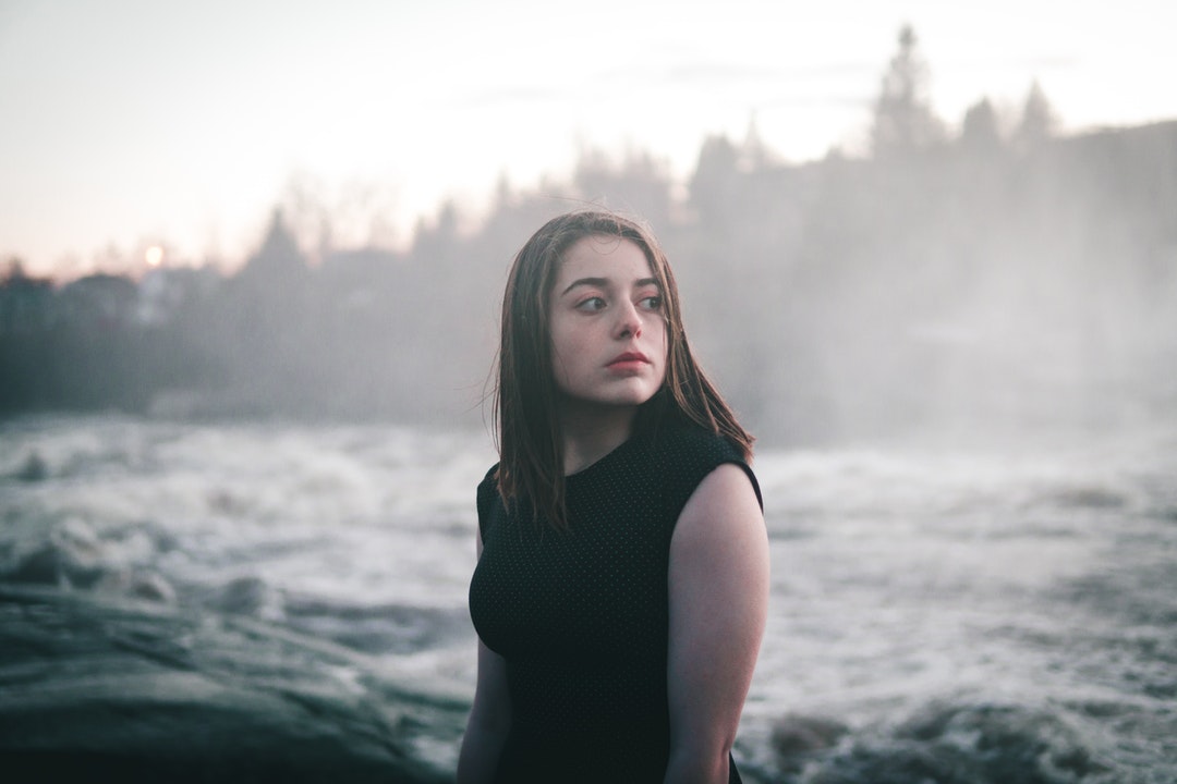 woman standing beside sea